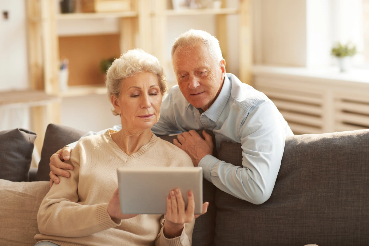 A family member holding hands with a senior loved one.