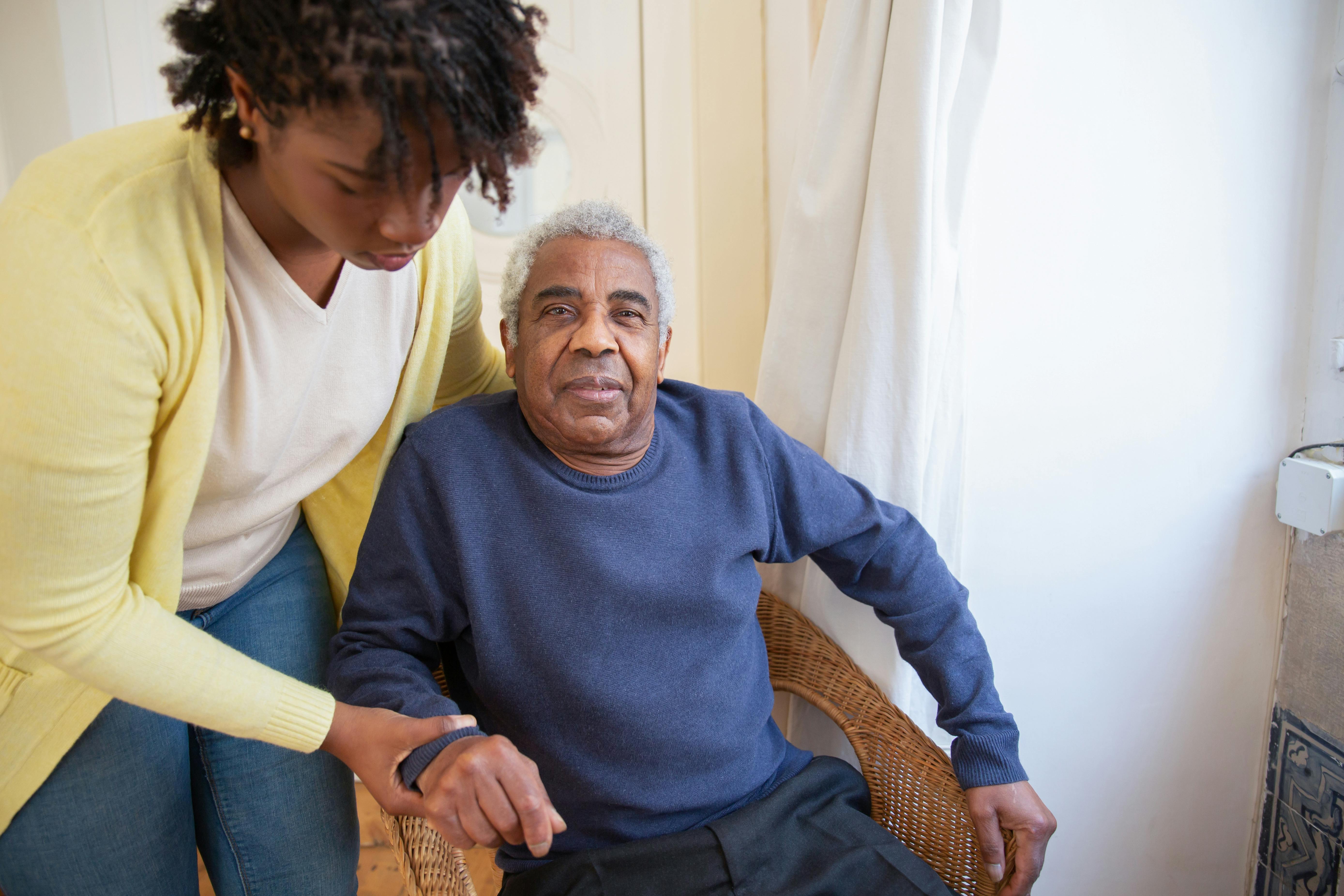 A family member holding hands with a senior loved one.